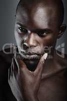 Hes the silent thinking type. An african male looking thoughtful in studio.