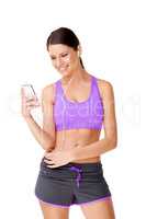 Tunes to workout with.... Shot of a sporty young women listing to music on an mp3 player isolated on white.