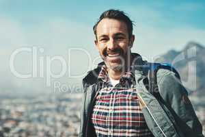 Smiles are forms of happiness found right under our noses. Portrait of a middle aged man smiling in front of a mountain landscape.