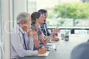 Excuse me.... Cropped shot of a group of businesspeople sitting in a meeting.