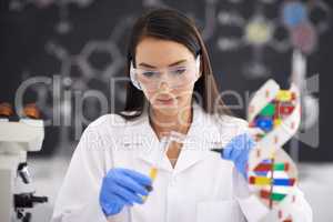 Advancement in genetics improving life. Shot of a female scientist pouring liquid into a test tube.