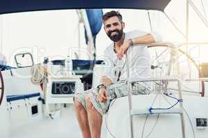 Youll never regret owning a yacht. Cropped shot of a handsome mature man on his yacht.