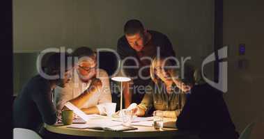 The way forward, is together. Cropped shot of a group of businesspeople working together around a table in their office.