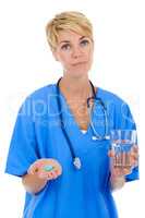 As prescribed by me. A young female doctor holding pills and a glass of water.