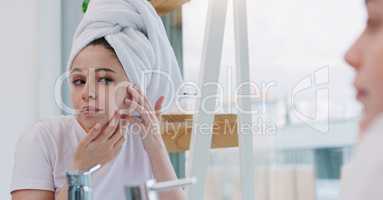 Keeping my skin hydrated. Shot of a young woman cleaning her face.