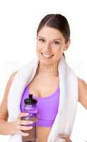 Staying hydrated equals staying healthy. Studio portrait of a sporty young woman with a towel draped over her shoulders and holding a water bottle isolated on white.