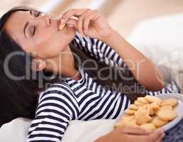 Om nom nom nom. A young woman enjoying a plate of cookies.