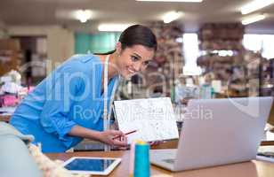 So what do you think. A young designer showing her designs to someone during a video conference.