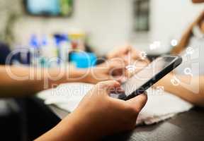 This is so relaxing. Closeup of a unrecognisable woman texting on her phone while receiving a manicure inside of a day spa.