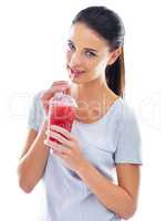 Quench your thirst for a fruit burst. Studio shot of a beautiful young woman enjoying a fruit smoothie.