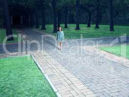 Shot of a child standing in the centre of a four way intersection in the park - ALL design on this image is created from scratch by Yuri Arcurs team of professionals for this particular photo shoot