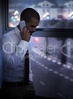 Shot of a businessman talking on his cellphone late at night. Real life businesspeople shot on location. Since these locations are the real thing, and not shot in an office studio, high ISO levels are sometimes needed to catch the moment. The ISO range is