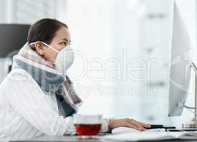 Survival of the focused. Shot of a masked young businesswoman using a computer in a modern office.