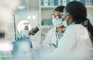 Science enhances critical thinking. Shot of two scientists working together on a computer in a lab.