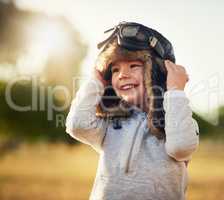 This little lad has big dreams. Shot of a cute little boy wearing a pilots hat and goggles while playing outside.