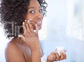 No to dark spots, yes to luminosity. Shot of a beautiful young woman during her daily beauty routine.