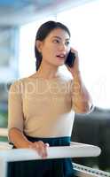 Stay close to clients to grow your business. Shot of a young businesswoman talking on a cellphone in an office.