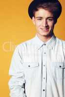 Happy to be me. Portrait of a young man wearing a hat and smiling widely at the camera.