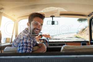 Comfortable back there. Rearview portrait of a handsome man enjoying a summer roadtrip.