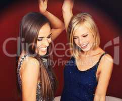 Feel the groove. Two young women dancing in a club.