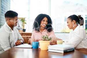 Every contribution is a valuable contribution. Shot of a group of young businesspeople having a meeting in a modern office.