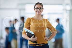 Im taking my business to the top. Portrait of a young office worker standing in an office with colleagues in the background.