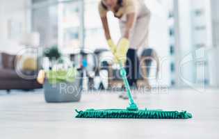 The countdown to clean, shiny floors. Shot of an unrecognisable woman mopping the floor at home.