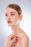 Highlighting her most beautiful features. Portrait of an attractive young woman wearing bright red lipstick and nail polish.