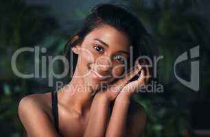 Pure beauty lies in being your unique self. Shot of a beautiful young woman posing against a dark background.