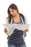 Navigating an unfamiliar city. A beautiful young tourist looking at a map while isolated on a white background.