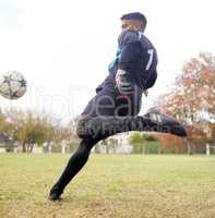 Exercise not only changes your body, it changes your mind. Shot of a young man playing soccer on a field.