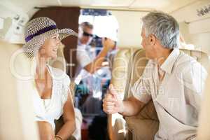 Getting the go-ahead. Mature couple talking to the pilot while on a private jet and headed on a trip.