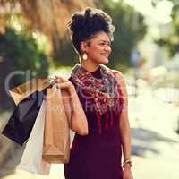 I use everything as an excuse to go shop. Cropped shot of a young woman doing some shopping in the city.