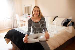 Im ready for the weekend. Portrait of an attractive young woman sitting crossed-legged on her bed.