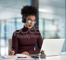 The key is to prioritise. Shot of a young female agent listening intently while working in a call centre.