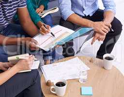 The best ideas are caffeine driven. Cropped shot of a group of designers having a discussion.