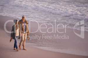 Forever is not enough with you. Shot of a young couple enjoying a romantic stroll on the beach.