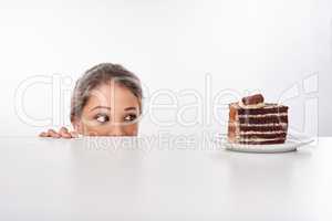 Shes a lover of chocolate. Studio shot of an attractive young woman being tempted by something sweet.