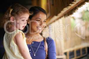 Enthralled by what shes seeing.... Cropped shot of a mother and daughter looking at a marine life attraction.