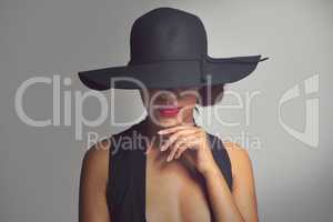 Beauty with a hint of mystery. Studio shot of a stylishly dressed young woman.