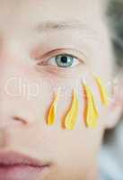 Beauty treatment. Cropped shot of a young mans face with flower petals under his eye while looking at the camera.