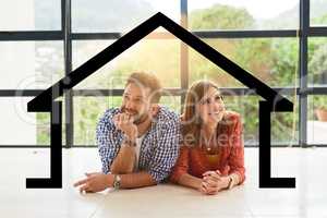 Imagine owning our dream house.... Shot of a young couple dreaming about a new house.