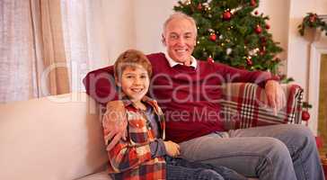 Have yourself a Merry little Christmas. Shot of a young boy and his granddad on Christmas.