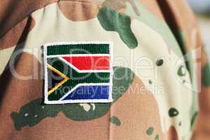 Proud fighting man. Cropped closeup shot of a South African flag on a soldiers uniform.