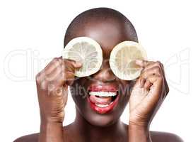 When life hands you lemons, act the fool. Studio shot of a beautiful model holding lemon slices up to her eyes.