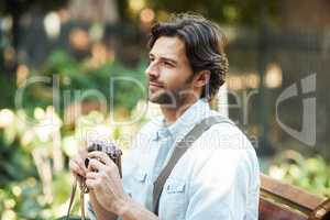 Replace fear of the unknown with curiosity. Shot of a handsome young tourist checking out the sights.