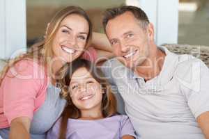 Happiness is home made. A cropped shot of a beautiful family relaxing comfortably at home.