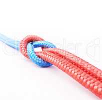 Its a strong bond. Studio shot two ropes knotted together isolated on white.
