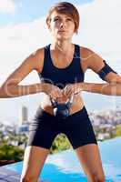 Enjoying a rhythmic workout. Shot of a woman working out with a dumbbells.