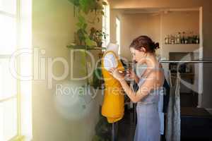 Cutting the perfect fit. A young designer making a garment in her workplace.